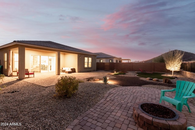 exterior space featuring a patio and an outdoor fire pit