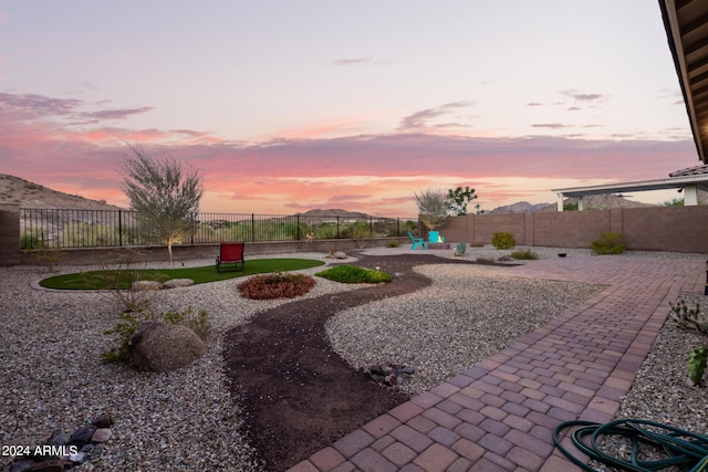 yard at dusk with a patio area