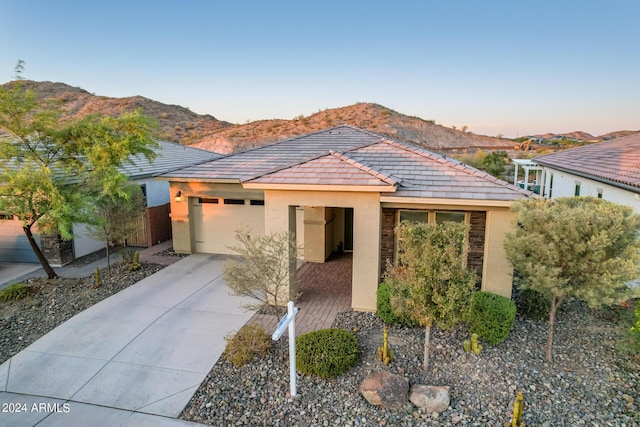 view of front of property with a garage and a mountain view