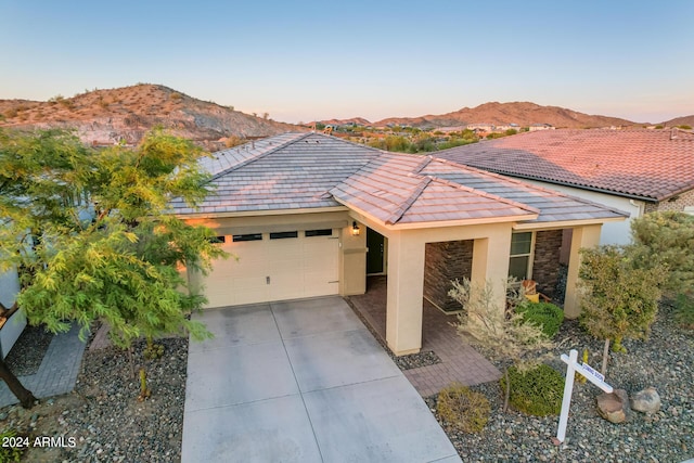 single story home featuring a mountain view and a garage