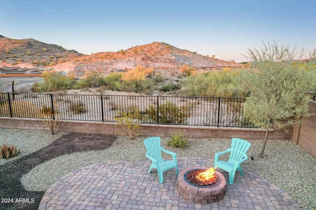 view of patio featuring a mountain view and a fire pit