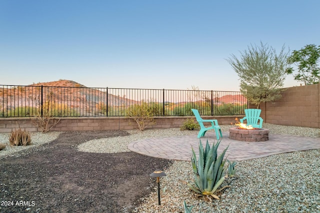 patio terrace at dusk featuring a fire pit