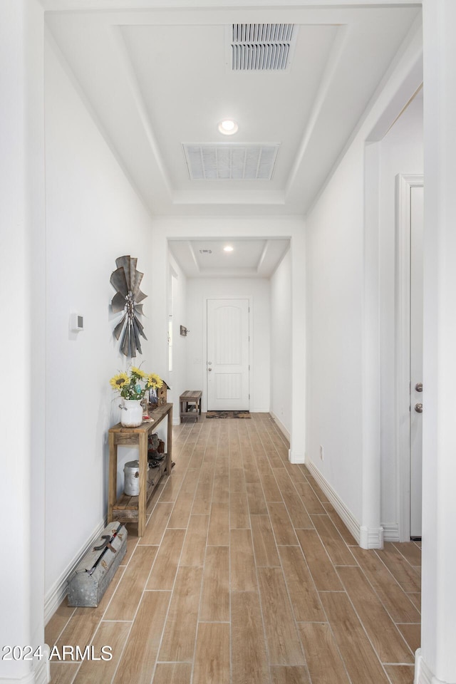 hallway with a raised ceiling