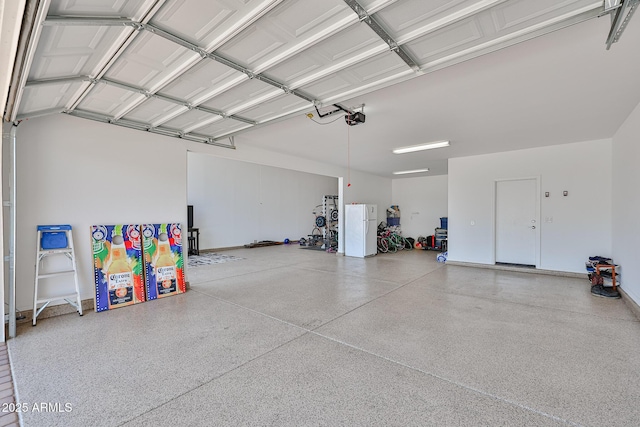 17819 W Georgia Ave, Litchfield Park, AZ 85340 - garage featuring a garage door opener and freestanding refrigerator