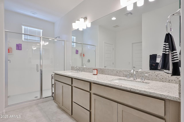 17819 W Georgia Ave, Litchfield Park, AZ 85340 - bathroom with a stall shower, double vanity, marble finish flooring, and recessed lighting