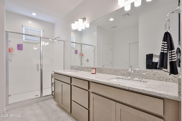 17819 W Georgia Ave, Litchfield Park, AZ 85340 - full bathroom featuring a shower stall, double vanity, recessed lighting, and marble look tile flooring