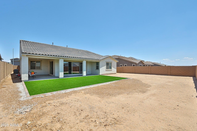 17819 W Georgia Ave, Litchfield Park, AZ 85340 - back of house featuring a fenced backyard, a tiled roof, a patio, and stucco siding