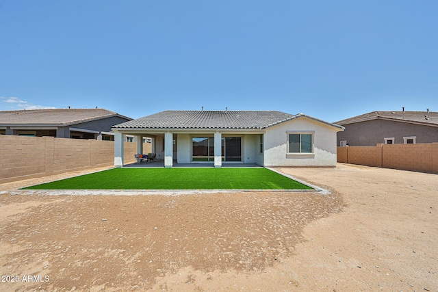 17819 W Georgia Ave, Litchfield Park, AZ 85340 - rear view of house with a fenced backyard, stucco siding, a tiled roof, and a patio area