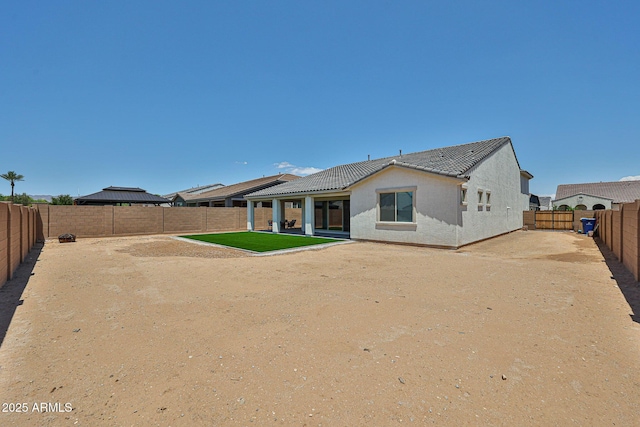 17819 W Georgia Ave, Litchfield Park, AZ 85340 - rear view of house featuring a fenced backyard, stucco siding, a patio, and a tiled roof