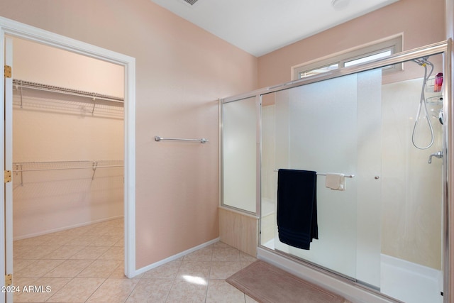 bathroom featuring tile patterned flooring and walk in shower