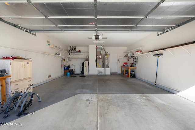 garage with a garage door opener and water heater