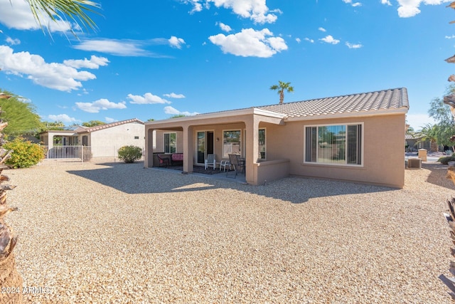 back of property with central air condition unit and a patio