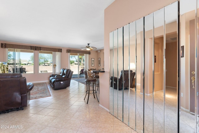 interior space featuring ceiling fan and light tile patterned floors