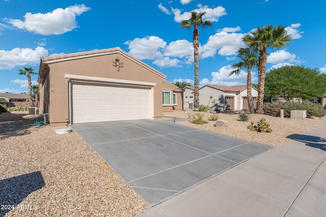 view of front of property with central AC and a garage