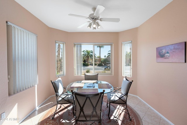 tiled dining space with ceiling fan