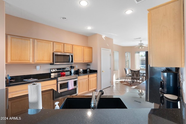 kitchen with sink, ceiling fan, light tile patterned floors, light brown cabinetry, and stainless steel appliances