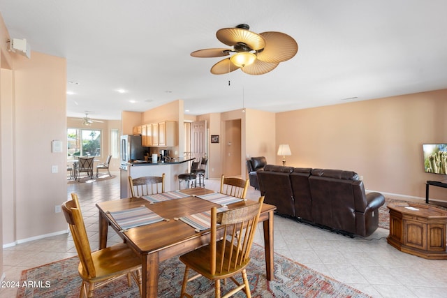 dining room with light tile patterned floors and ceiling fan