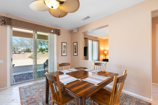 tiled dining room featuring ceiling fan