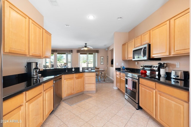 kitchen with sink, ceiling fan, light brown cabinetry, appliances with stainless steel finishes, and kitchen peninsula