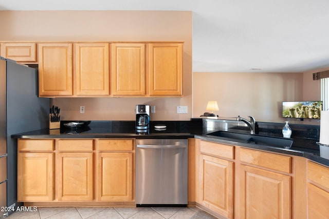 kitchen featuring sink, stainless steel dishwasher, refrigerator, light brown cabinetry, and light tile patterned floors