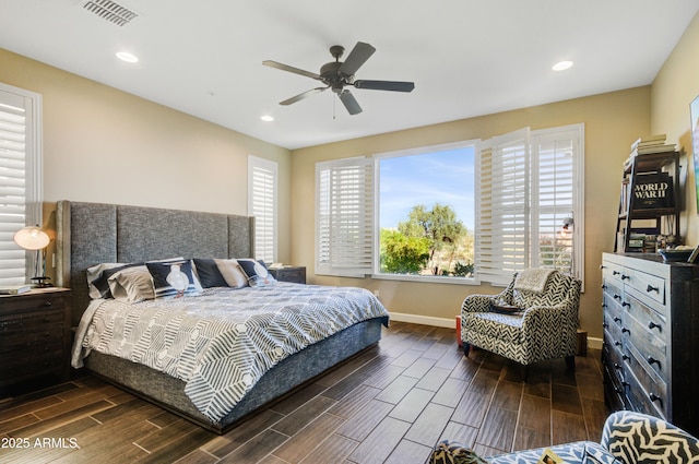 bedroom with ceiling fan and multiple windows