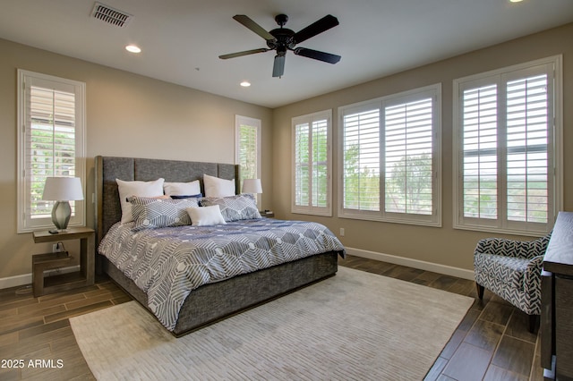 bedroom featuring multiple windows and ceiling fan