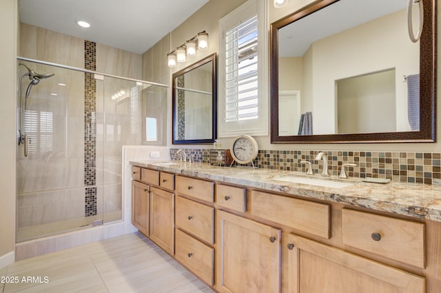 bathroom featuring decorative backsplash, vanity, an enclosed shower, and tile patterned flooring