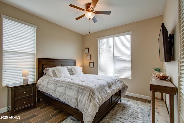 bedroom with ceiling fan and dark hardwood / wood-style floors