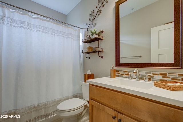 bathroom with decorative backsplash, vanity, and toilet