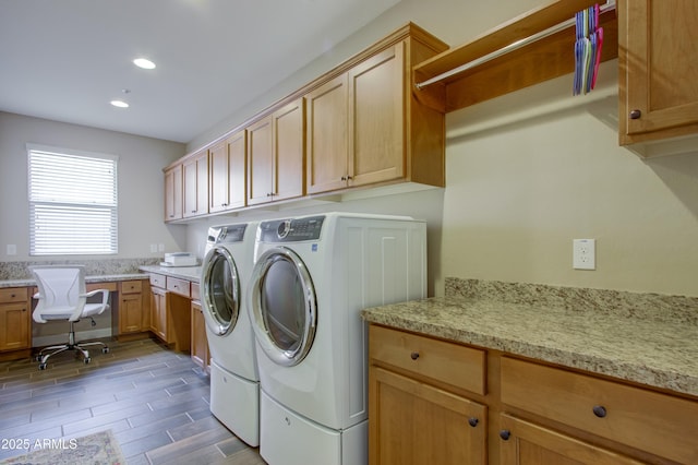 washroom featuring cabinets and separate washer and dryer