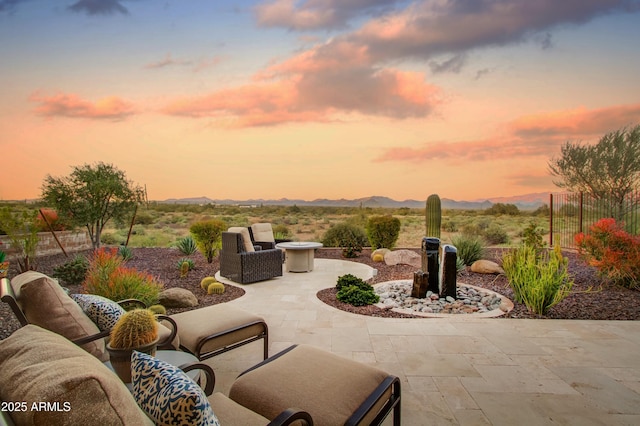 patio terrace at dusk with a mountain view