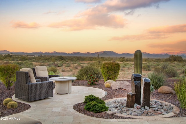 patio terrace at dusk with a mountain view