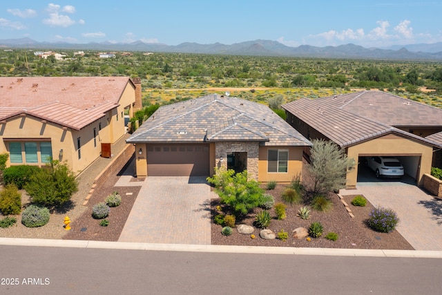 view of front facade featuring a mountain view and a garage