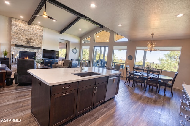 kitchen with dishwasher, sink, a center island with sink, and a wealth of natural light