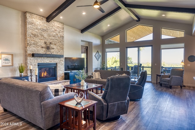 living room featuring beam ceiling, ceiling fan, high vaulted ceiling, dark wood-type flooring, and a stone fireplace