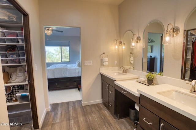 bathroom with vanity, ceiling fan, and wood-type flooring