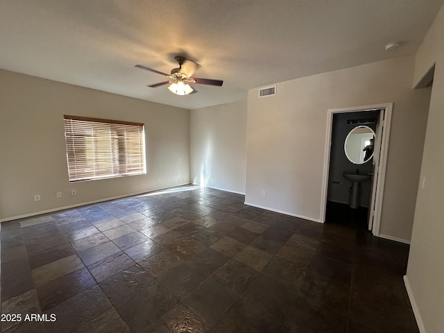 unfurnished room with ceiling fan and sink