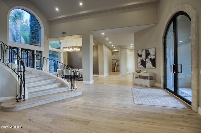 entryway with a high ceiling and light wood-type flooring