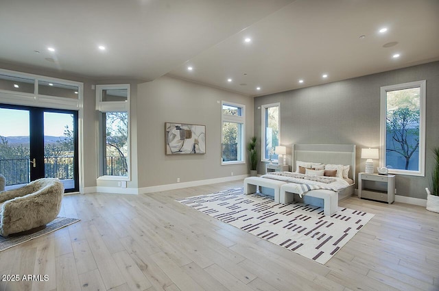 bedroom featuring french doors, access to exterior, and light hardwood / wood-style flooring