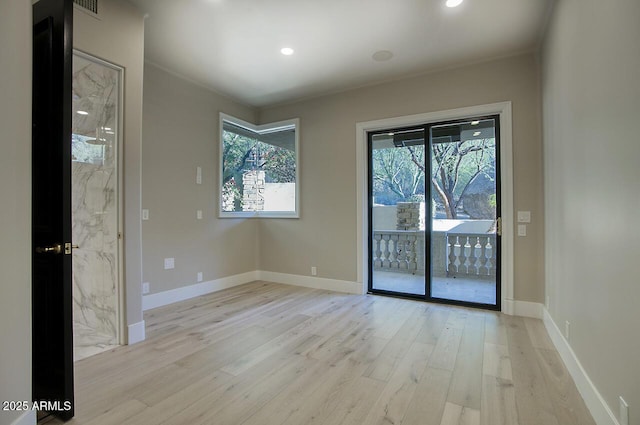 unfurnished room with light wood-type flooring