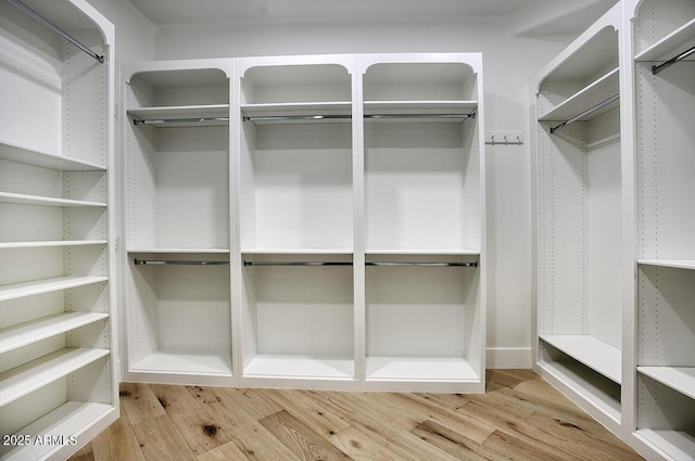 spacious closet with light hardwood / wood-style floors