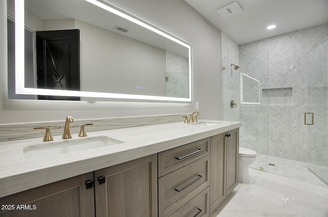 bathroom featuring vanity, toilet, and an enclosed shower