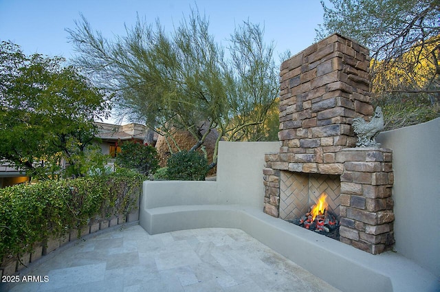 view of patio / terrace with an outdoor stone fireplace