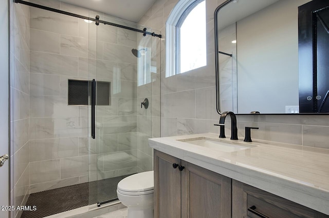 bathroom featuring vanity, toilet, and an enclosed shower