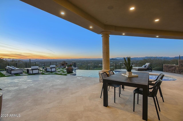 patio terrace at dusk featuring outdoor lounge area and a mountain view