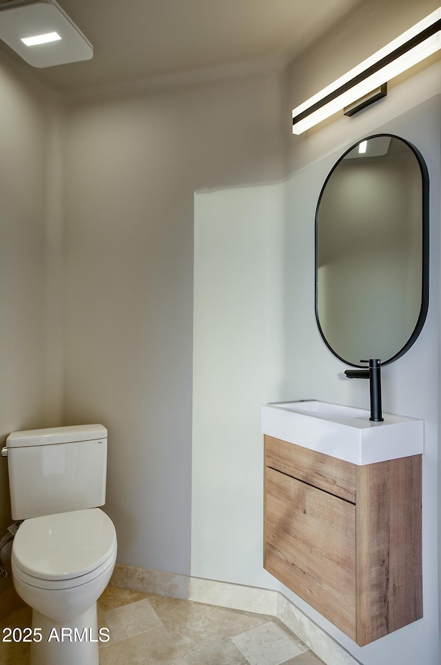 bathroom featuring vanity, tile patterned floors, and toilet