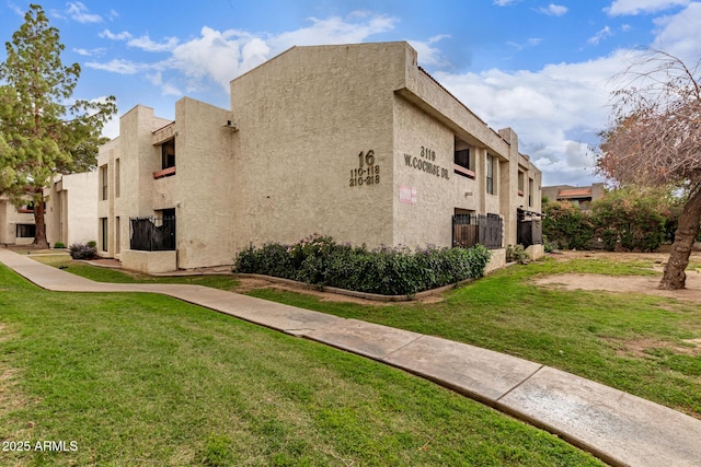 3119 W Cochise Dr Unit 111, Phoenix, AZ 85051 - view of property exterior with a yard and stucco siding