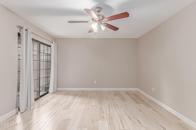 3119 W Cochise Dr Unit 111, Phoenix, AZ 85051 - empty room featuring a ceiling fan, wood finished floors, and baseboards