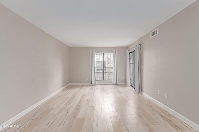 3119 W Cochise Dr Unit 111, Phoenix, AZ 85051 - spare room featuring light wood-style floors and baseboards