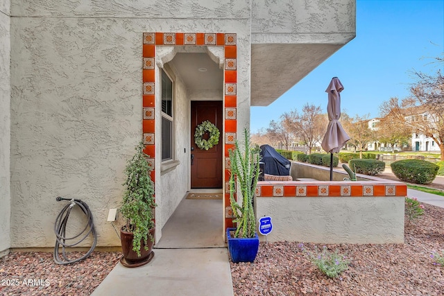 property entrance with stucco siding